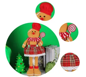 Detail of gingerbread plush doll with red chef hat and green tartan skirt decor