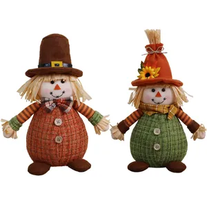 Pair of autumn Thanksgiving scarecrow dolls with sunflower and maple leaf details