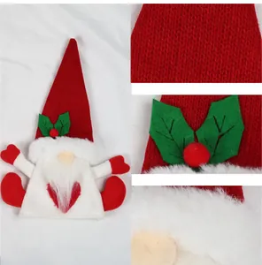 Detailed view of knitted Christmas wine bottle gnome with red heart and faux fur textures