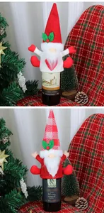 Close-up of festive Christmas gnome wine bottle covers with knitted details and pine cone decor