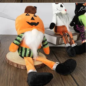 Detailed view of Halloween plush gnomes with pumpkin heads and long sequined legs
