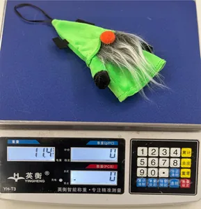 Detail showing a green Halloween plush gnome weight measurement on a digital scale