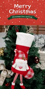 Detail of red Christmas stocking with 3D plush long-legged gnome and snowflake embroidery