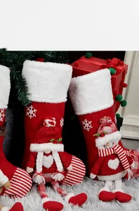 Detailed view of plush Christmas stockings featuring 3D snowman and festive embroidery