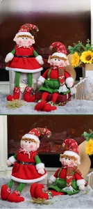 Close-up of plush Christmas elf dolls featuring red and green outfits and festive hats