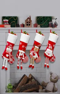 Detail of plush Christmas stockings featuring 3D snowman, reindeer, and Santa characters