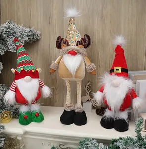 Detailed view of three festive faceless Christmas gnomes on a decorated fireplace mantel