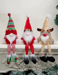 Close-up of three festive Christmas gnomes with reindeer antlers sitting on a white mantel