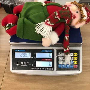 Detailed close-up showing a 295g Christmas elf plush doll on a scale for weight check