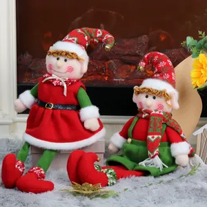 Plush Christmas elf dolls with telescopic legs and striped hats in festive fireplace scene