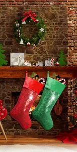 Close-up of red and green sequined Christmas stockings hanging by a brick fireplace