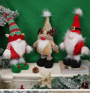 Detailed close-up of three Christmas gnome dolls with sequined antlers and knitted hats