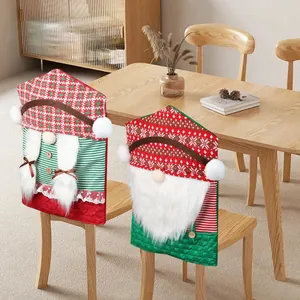 Two Christmas gnome chair covers with braided hair and beards for festive dining room decor