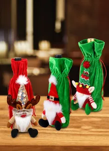 Detailed view of plush Christmas wine bottle covers with reindeer and gnome embroidery