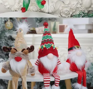 Three plush Christmas gnomes with reindeer antlers and knit hats sitting on a table