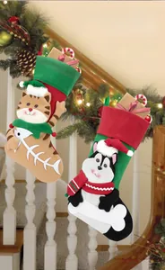 Detail of cartoon cat and dog Christmas stockings hanging on decorated stairs