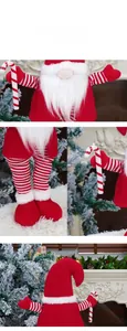 Detail of a Christmas faceless gnome featuring a red knit hat and striped long legs