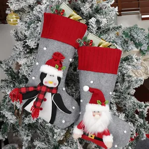 Christmas stocking set with Santa and Penguin designs on a snowy Christmas tree