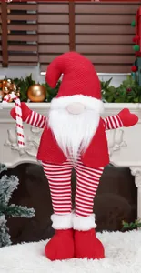 Detailed close-up of a Christmas gnome doll featuring a red knit hat and white beard