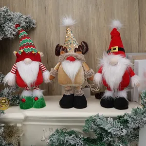 Three festive Christmas gnomes with long white beards on a snowy mantelpiece decoration