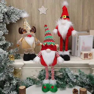 Three plush Christmas faceless gnomes with reindeer and elf hats on a festive mantel