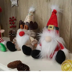 Close-up of faceless Christmas gnomes with reindeer antlers and red holiday hats