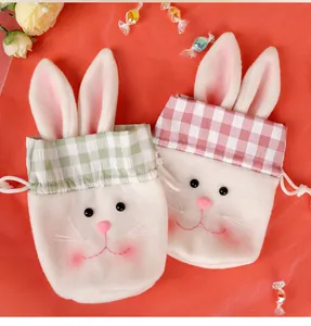 Close-up of Easter bunny drawstring bags in plush beige with colorful plaid ears