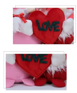 Detail of plush gnomes holding a red felt heart with LOVE text for Valentine decor