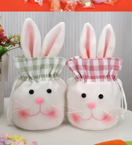 Detail view of plush bunny drawstring gift bags in pink and green plaid patterns