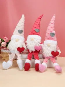 Three Valentine gnomes with plush hats and hearts on decorative white books