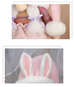 Detail of plush bunny with long ears, white braids, and a purple ribbon with pearl bead