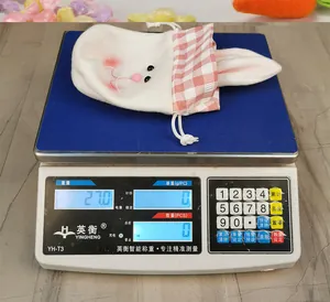 Close-up of Easter rabbit gift bag on digital scale showing weight of 27.0g