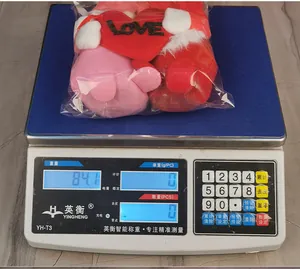 Weight measurement of a pair of Valentine's Day plush gnomes with Love heart in packaging