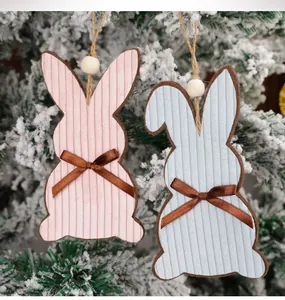 Detailed view of pink and blue corduroy Easter bunny charms with wooden beads and bows