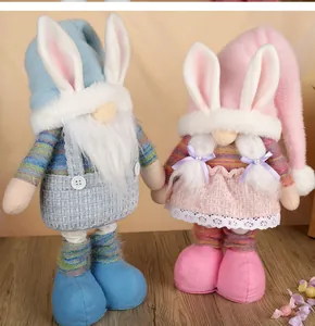 Detail of Easter gnome plush set with long rabbit ears and adjustable legs on wood floor