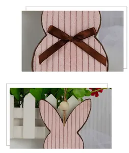 Detailed macro shot of striped Easter rabbit ornament with brown bow and wood bead