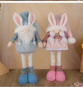 Detail of Easter gnomes with rabbit ears and retractable legs in blue and pink outfits