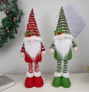 Detail of two Nordic Christmas gnomes with striped hats and long legs for home decor