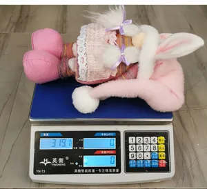 Detail shot of the plush bunny gnome on a scale showing a weight of 319.1g for Easter decor