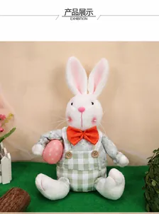 Easter gnome plush bunny wearing green checkered overalls holding a pink spotted egg