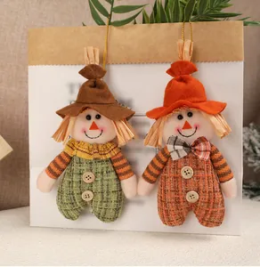 Close-up of autumn scarecrow plush ornaments with golden hanging ropes for harvest decor