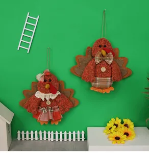 Detail of fabric Thanksgiving turkey ornaments with lace and bow on green backdrop