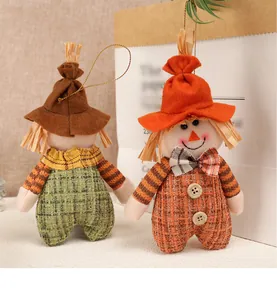 Close-up of autumn scarecrow pendants with colorful plaid patterns and wooden button detail