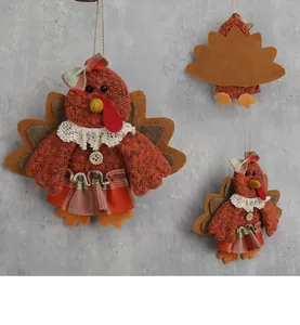 Detail of fabric Thanksgiving turkey ornaments showing tweed texture and lace collar
