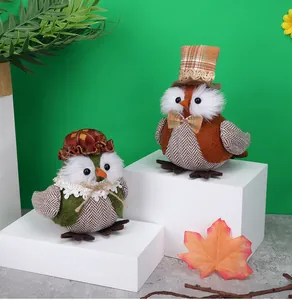 Close-up of autumn owl fabric dolls with plaid hats and lace details for holiday decor