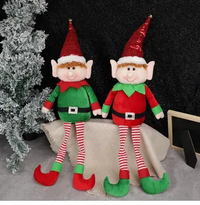 Close-up of Christmas elf dolls with sequined hats and jingle bells on a festive display