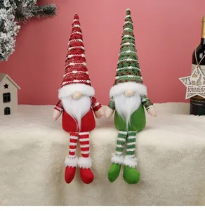 Close-up of Christmas gnome plush toys with long striped legs and knitted hats