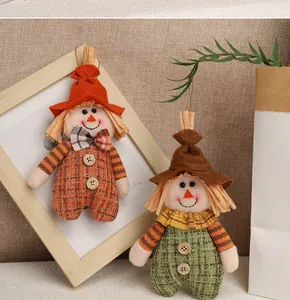 Detail view of handmade plush autumn scarecrow hanging ornaments for festive harvest decoration