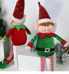 Detailed view of Christmas elf dolls with sequined hats, golden bells, and striped legs