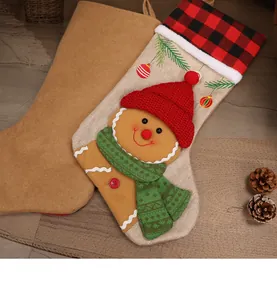 Detailed view of rustic burlap Christmas stocking with 3D gingerbread man and plaid trim